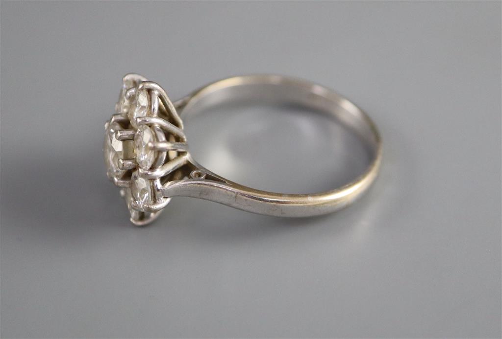 A modern 18ct white gold and eight stone diamond cluster flower head ring,